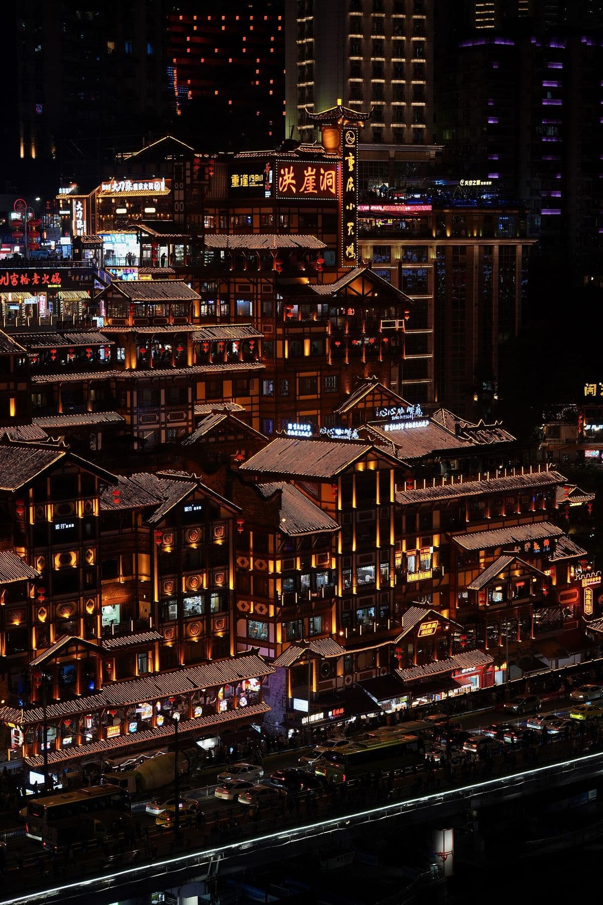Hongyadong's stilted houses glowing gold at night in Chongqing
